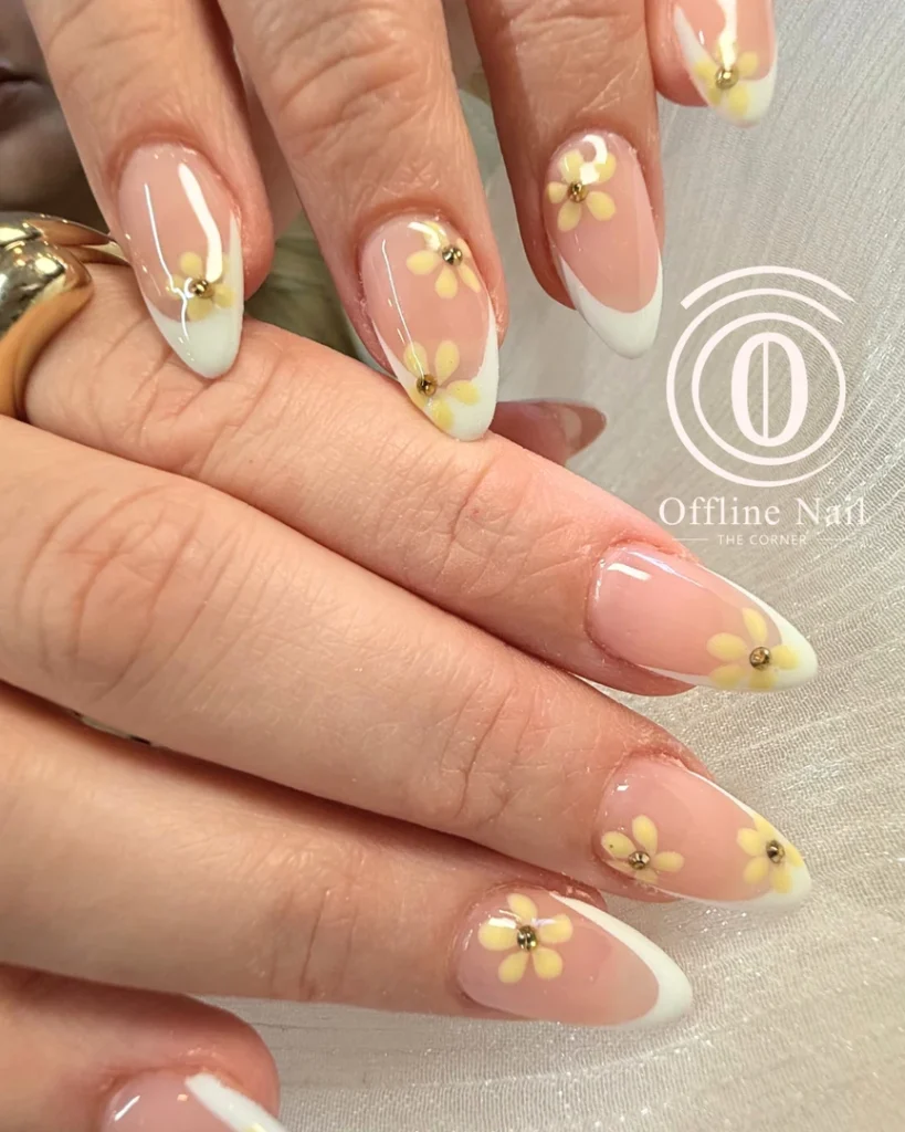 Hand-painted daisies on almond French tips
